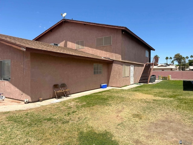 1234 W 20th Pl, Yuma, AZ 85364 - back of property featuring stairway and stucco siding