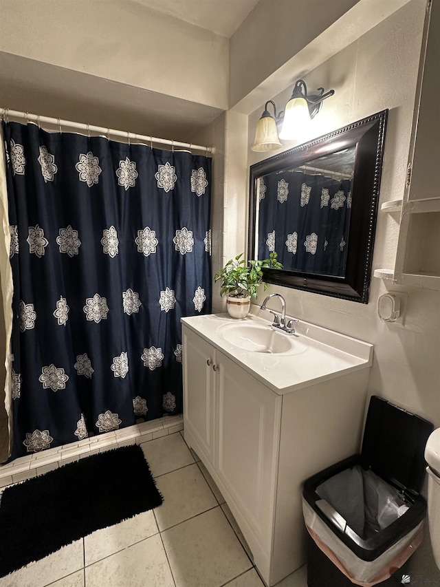 bathroom with vanity, tile patterned flooring, toilet, and curtained shower