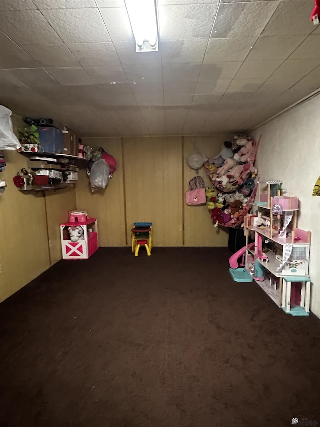 rec room with dark colored carpet