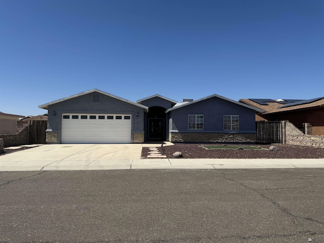 10310 E 37th Pl, Yuma, AZ 85365 - single story home with an attached garage, stone siding, driveway, and stucco siding