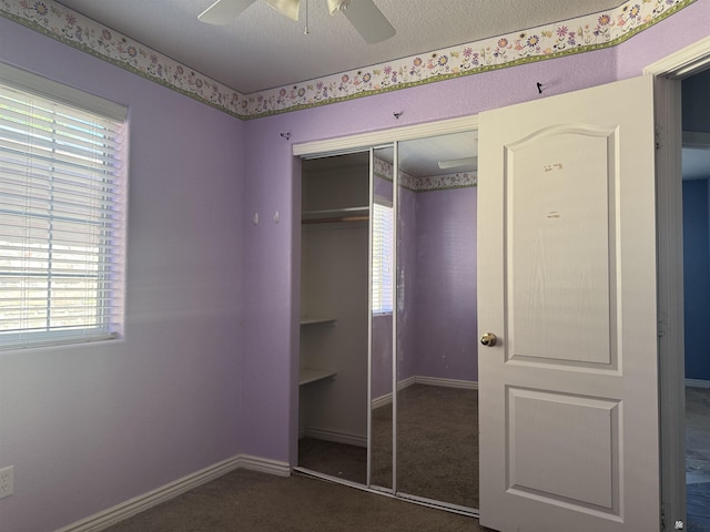 10310 E 37th Pl, Yuma, AZ 85365 - unfurnished bedroom with a closet, carpet, multiple windows, and a ceiling fan