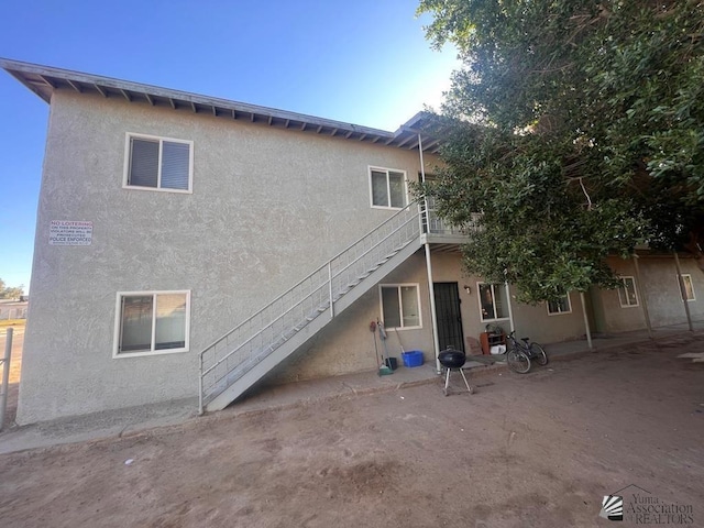 224 Somerton Avenue 224 & 230N. Somerton Ave, Somerton, AZ 85350 - rear view of property with stairs and stucco siding