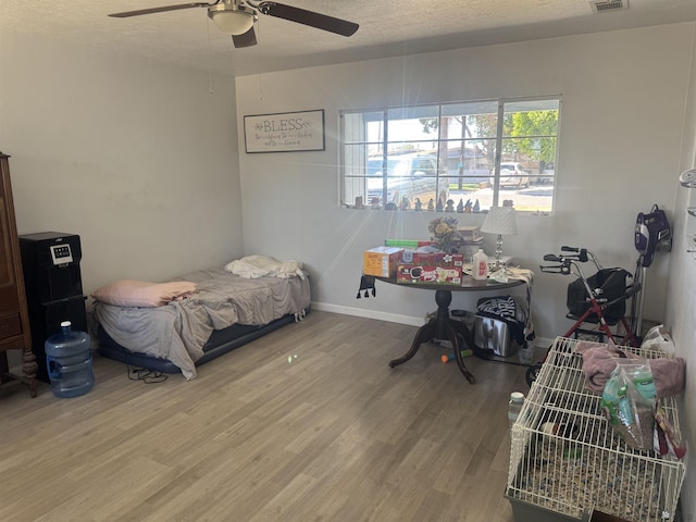 2681 S Walnut Ave, Yuma, AZ 85364 - bedroom with wood finished floors, a ceiling fan, and a textured ceiling
