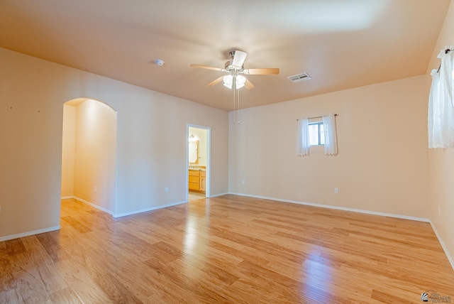 13736 S Chase Way, Yuma, AZ 85367 - empty room featuring baseboards, light wood finished floors, ceiling fan, visible vents, and arched walkways