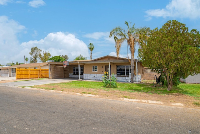 2556 W 14th St, Yuma, AZ 85364 - view of front of house with an attached carport, concrete driveway, and brick siding