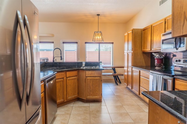 10453 S Del Rico, Yuma, AZ 85367 - kitchen with visible vents, brown cabinetry, a sink, and appliances with stainless steel finishes