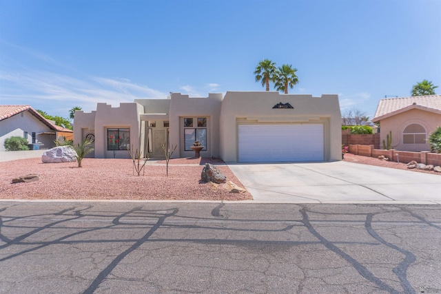 10453 S Del Rico, Yuma, AZ 85367 - pueblo revival-style home featuring an attached garage, stucco siding, and concrete driveway