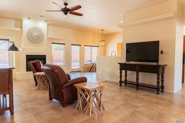 10453 S Del Rico, Yuma, AZ 85367 - living area featuring a ceiling fan, baseboards, a fireplace with raised hearth, and light tile patterned flooring