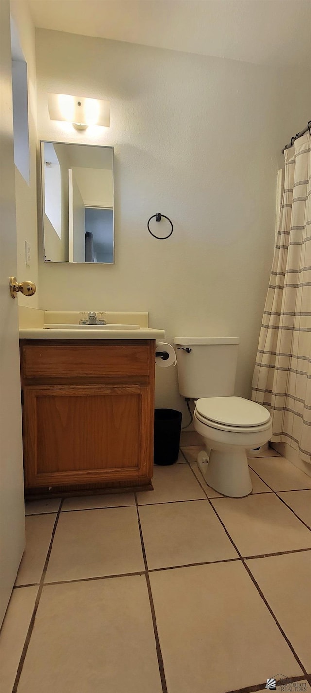 full bathroom with vanity, tile patterned floors, and toilet