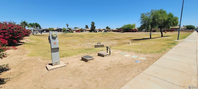 view of community featuring a lawn and a residential view