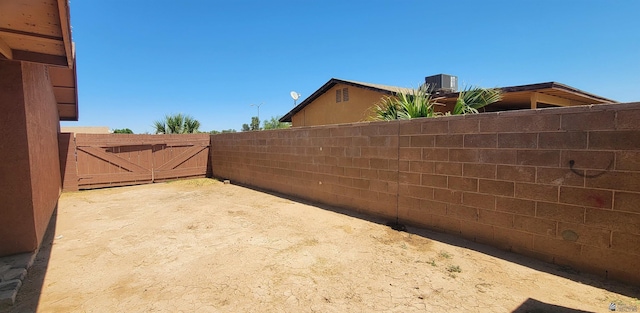 view of yard featuring fence and a gate