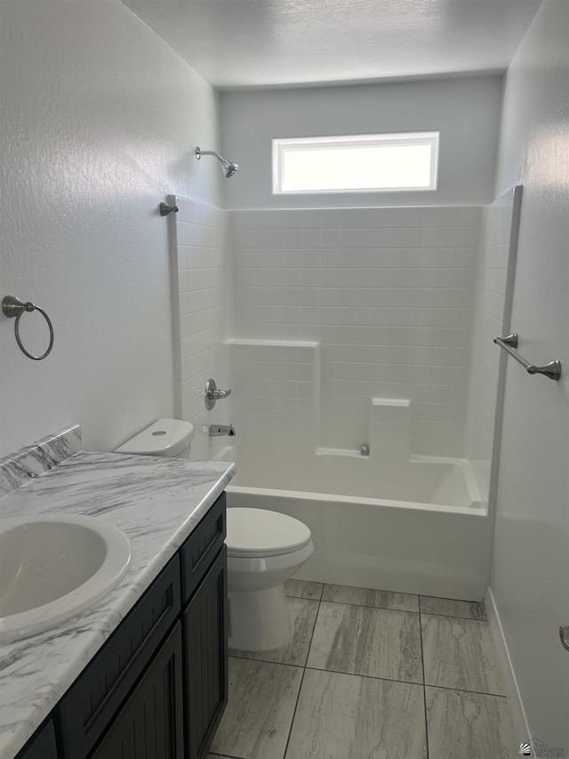 full bathroom featuring vanity, bathtub / shower combination, and toilet