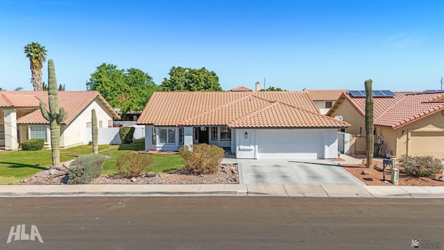 2032 W 13th Ln, Yuma, AZ 85364 - view of front of house featuring an attached garage, stucco siding, concrete driveway, and a tile roof