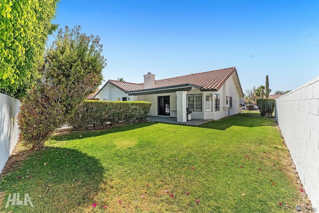 2032 W 13th Ln, Yuma, AZ 85364 - back of property with a chimney, a tiled roof, and stucco siding