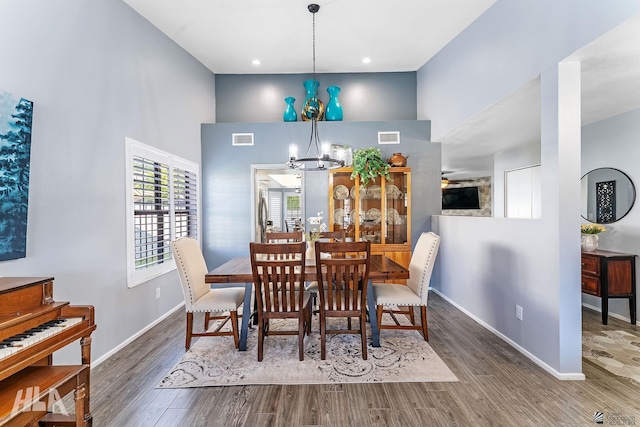 2032 W 13th Ln, Yuma, AZ 85364 - dining space featuring a towering ceiling, a chandelier, wood finished floors, and baseboards