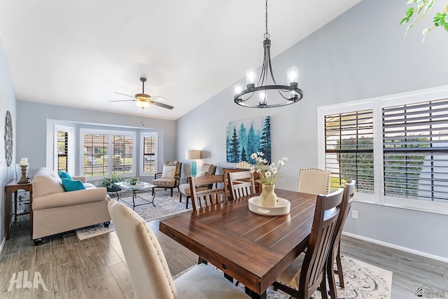 2032 W 13th Ln, Yuma, AZ 85364 - dining space featuring wood finished floors, a chandelier, a ceiling fan, high vaulted ceiling, and baseboards