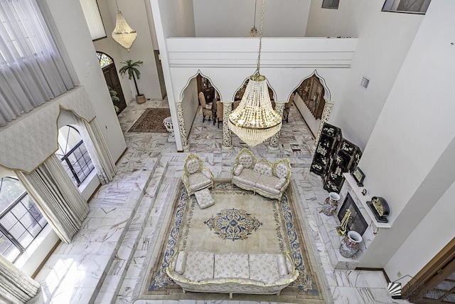 1376 S Hettema St, Yuma, AZ 85364 - living room featuring a towering ceiling, marble finish flooring, and a chandelier