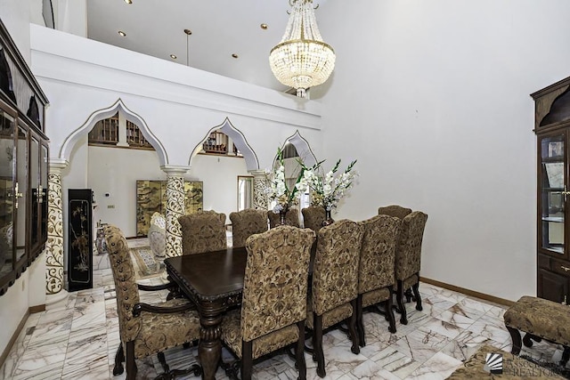 1376 S Hettema St, Yuma, AZ 85364 - dining space featuring light marble finish flooring, a chandelier, a towering ceiling, and baseboards