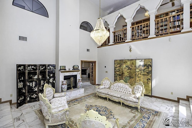 1376 S Hettema St, Yuma, AZ 85364 - living room featuring marble tiled floors, a chandelier, a towering ceiling, and baseboards