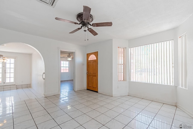 2320 S Maple Ave, Yuma, AZ 85364 - spare room with a ceiling fan, arched walkways, light tile patterned floors, and baseboards