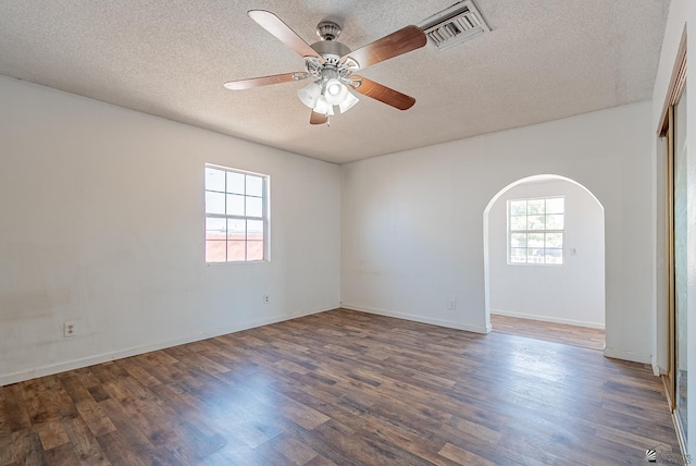 2320 S Maple Ave, Yuma, AZ 85364 - unfurnished room with arched walkways, a textured ceiling, wood finished floors, ceiling fan, and baseboards
