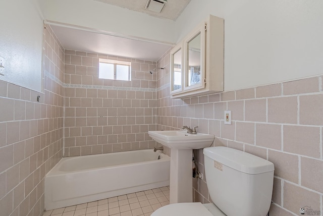 2320 S Maple Ave, Yuma, AZ 85364 - bathroom featuring toilet, shower / bath combination, tile walls, and tile patterned flooring