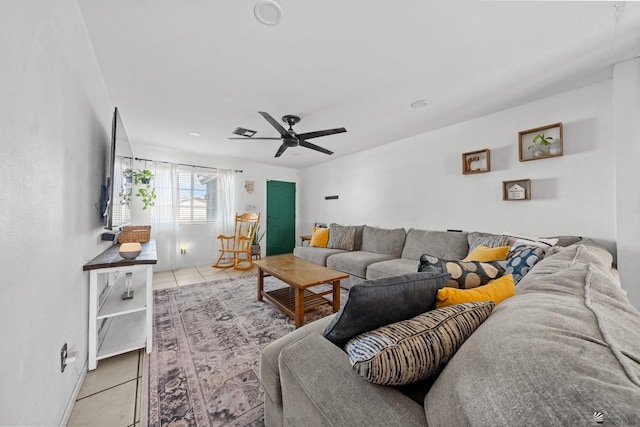 tiled living room with ceiling fan