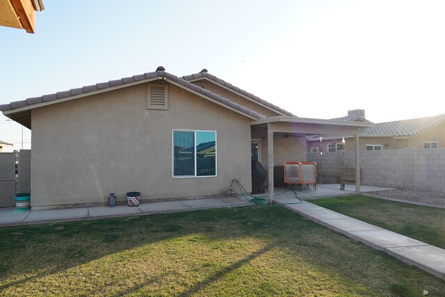 4780 W 11th Ln, Yuma, AZ 85364 - rear view of house with fence, ceiling fan, stucco siding, a patio area, and a lawn