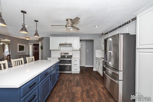 1830 W Allen St, Yuma, AZ 85364 - kitchen featuring stainless steel appliances, a ceiling fan, blue cabinetry, under cabinet range hood, and white cabinets