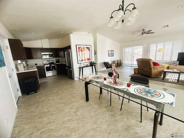 13624 E 47th St, Yuma, AZ 85367 - dining room featuring baseboards, visible vents, lofted ceiling, and ceiling fan with notable chandelier