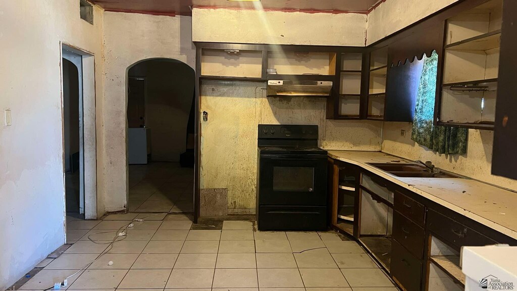 137 S 16th Ave, Yuma, AZ 85364 - kitchen featuring electric range, under cabinet range hood, light tile patterned flooring, light countertops, and a sink