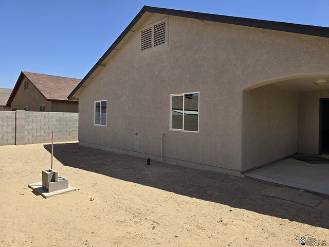 3822 E San Francisco St, San Luis, AZ 85336 - rear view of property featuring fence, a patio, and stucco siding