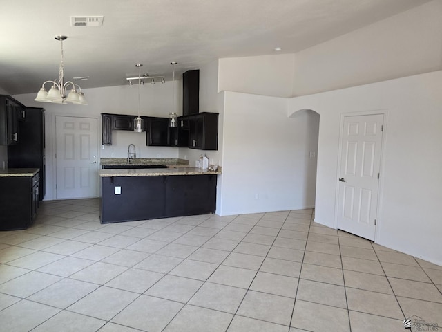 3822 E San Francisco St, San Luis, AZ 85336 - kitchen with visible vents, light stone countertops, a chandelier, dark cabinetry, and a sink
