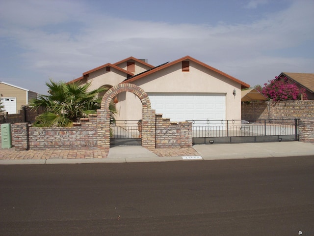 12650 E 46th St, Yuma, AZ 85367 - mediterranean / spanish-style house with a garage, driveway, fence private yard, and stucco siding