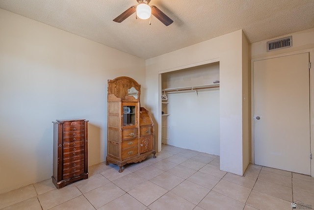 1871 S Mckinley Ave, Yuma, AZ 85364 - bedroom featuring a closet, light tile patterned flooring, a ceiling fan, and a textured ceiling
