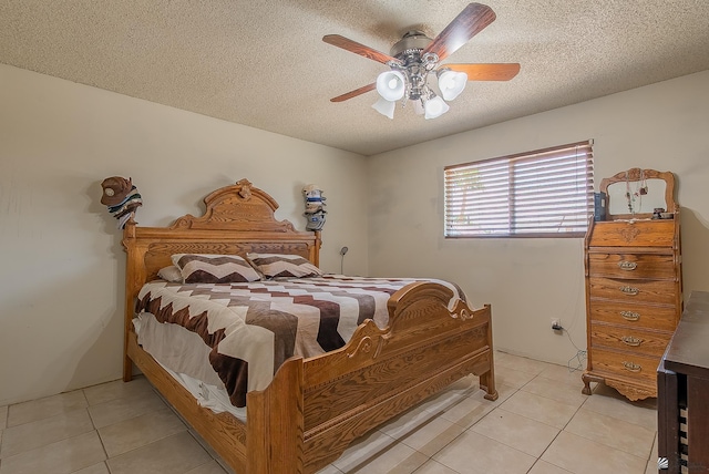 1871 S Mckinley Ave, Yuma, AZ 85364 - bedroom featuring light tile patterned floors, a textured ceiling, and ceiling fan