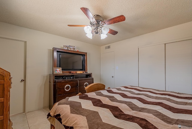 1871 S Mckinley Ave, Yuma, AZ 85364 - bedroom featuring light tile patterned floors, a textured ceiling, a ceiling fan, and a closet