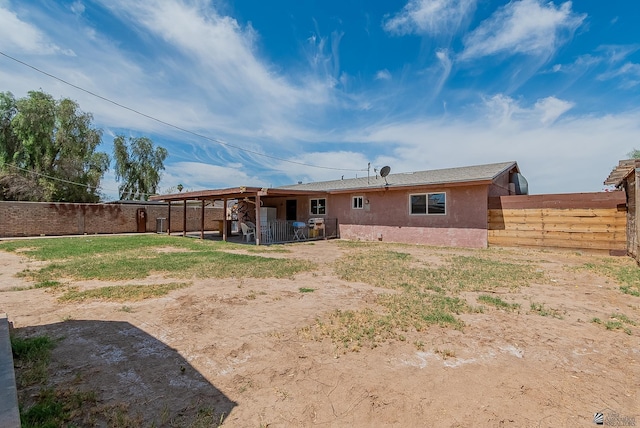 1871 S Mckinley Ave, Yuma, AZ 85364 - rear view of property with a fenced backyard, stucco siding, and a patio area