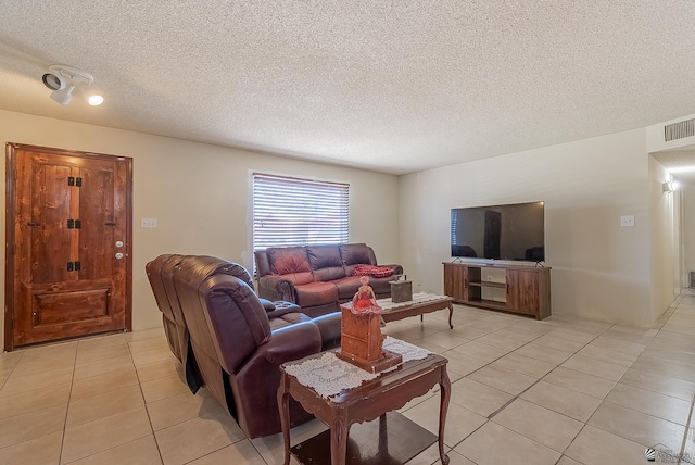 1871 S Mckinley Ave, Yuma, AZ 85364 - living room featuring light tile patterned floors and a textured ceiling
