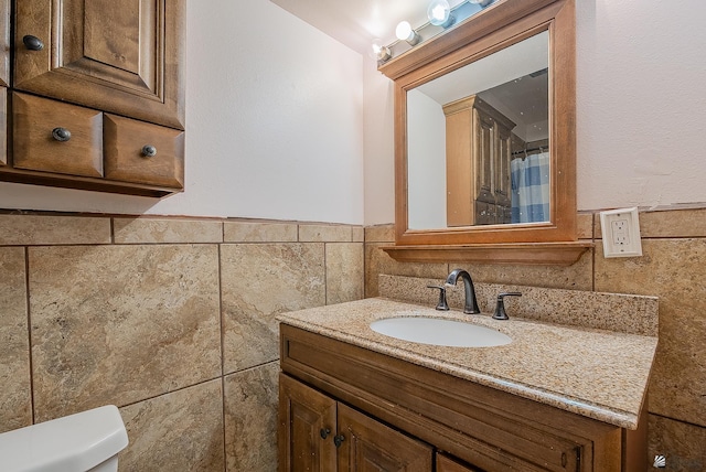 1871 S Mckinley Ave, Yuma, AZ 85364 - bathroom with tile walls, vanity, toilet, and wainscoting