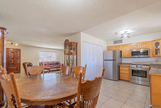 1871 S Mckinley Ave, Yuma, AZ 85364 - dining area featuring light tile patterned floors and a textured ceiling
