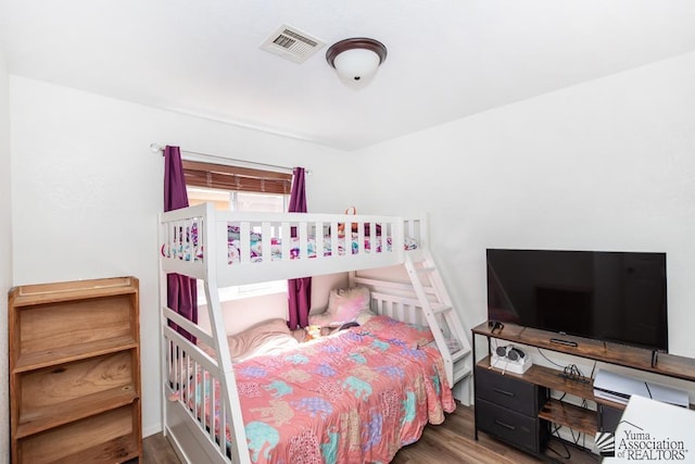 bedroom with visible vents and wood finished floors
