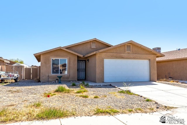 single story home with an attached garage, driveway, and stucco siding
