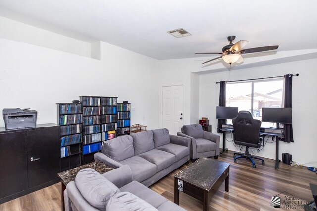 living room with visible vents, a ceiling fan, and wood finished floors