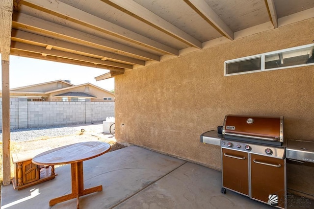 view of patio featuring fence and area for grilling