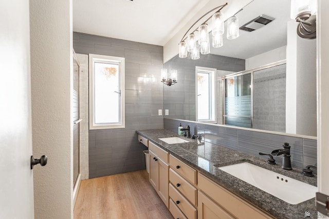 12500 E Del Rico, Yuma, AZ 85367 - bathroom featuring double vanity, tile walls, a sink, and a stall shower