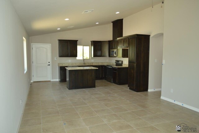 13132 E 55th Ln, Yuma, AZ 85367 - kitchen with black range with electric stovetop, lofted ceiling, a center island, dark brown cabinets, and stainless steel microwave