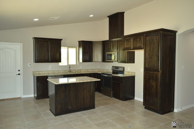 13132 E 55th Ln, Yuma, AZ 85367 - kitchen featuring electric range, stainless steel microwave, a center island, dark brown cabinets, and light tile patterned flooring