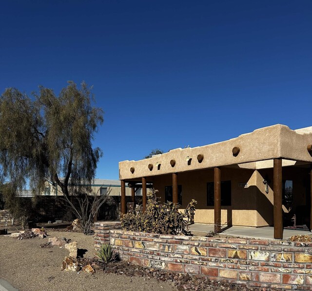 12696 E 45th Ln, Yuma, AZ 85367 - rear view of house with stucco siding, a patio area, and fence