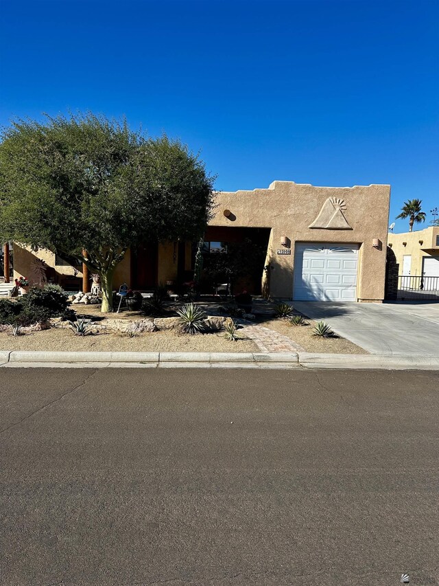 12696 E 45th Ln, Yuma, AZ 85367 - view of front of house with a garage, stucco siding, and concrete driveway